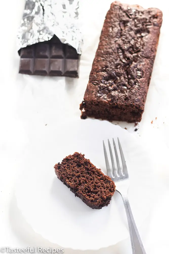 Overhead shot of vegan chocolate loaf cake with a dark chocolate bar