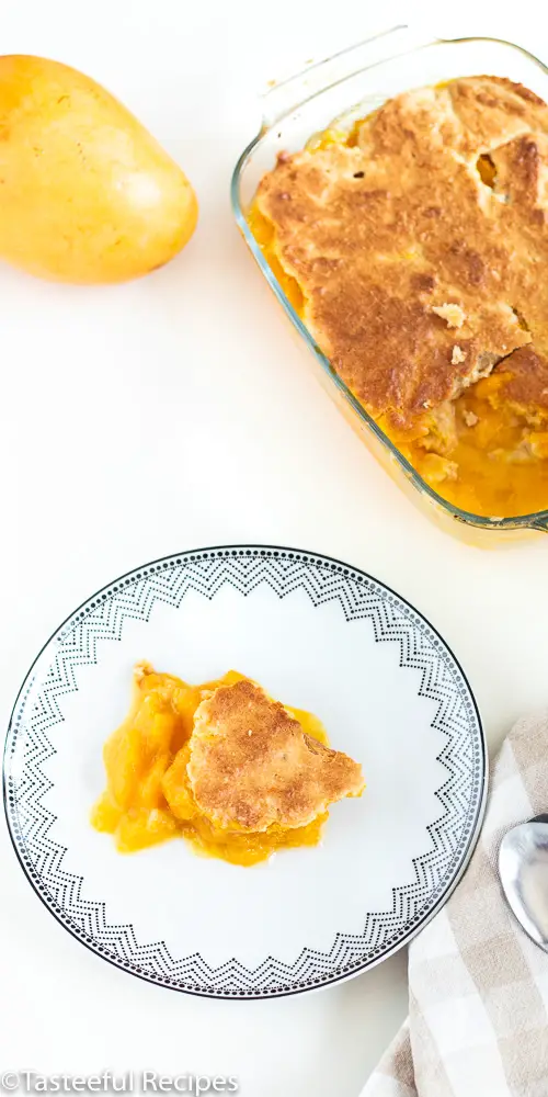 Angled shot of coconut mango cobbler on a plate