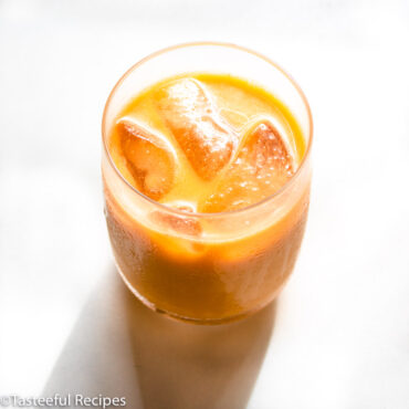 Angled shot of a glass of Caribbean carrot punch