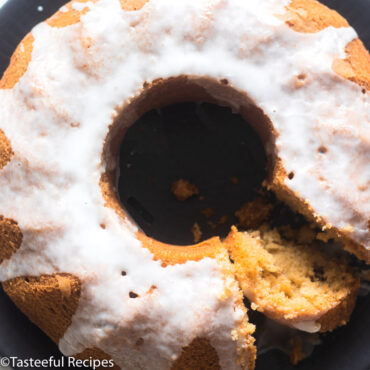 Overhead close-up shot of a whole rum & raisin cake topped with icing